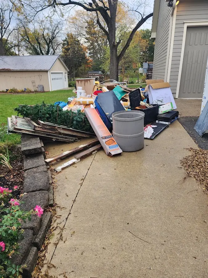 Dumpster being loaded with debris for Commercial Dumpster Rental in North Branch